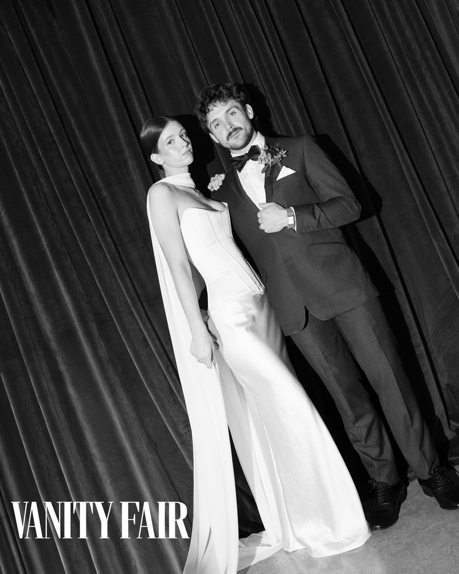 Sara & husband featured in Vanity Fair — B&W corset gown with cape sleeves against black velvet